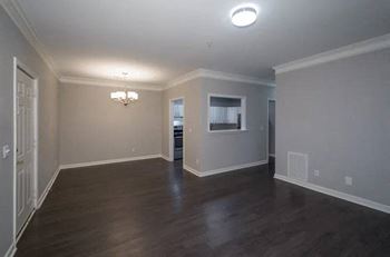 A room with wooden floors and a chandelier.